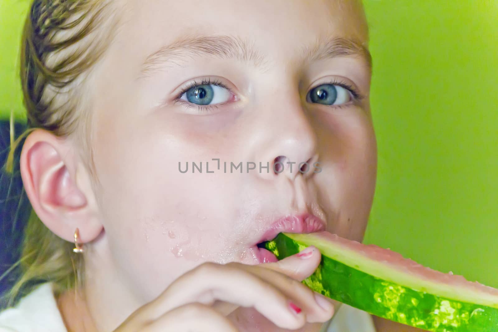 Photo of the cute girl eating watermelon