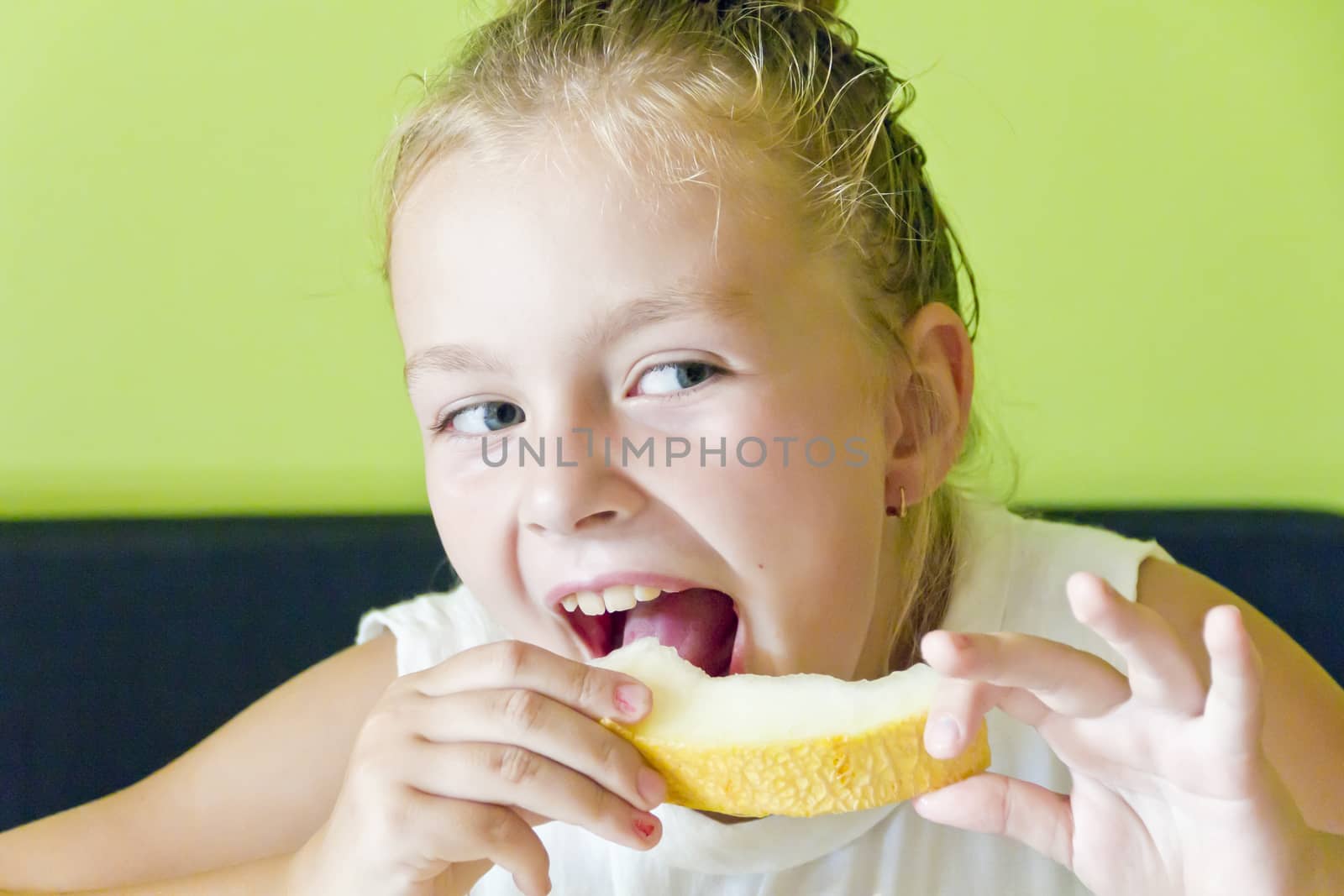 Photo of the cute girl eating melon