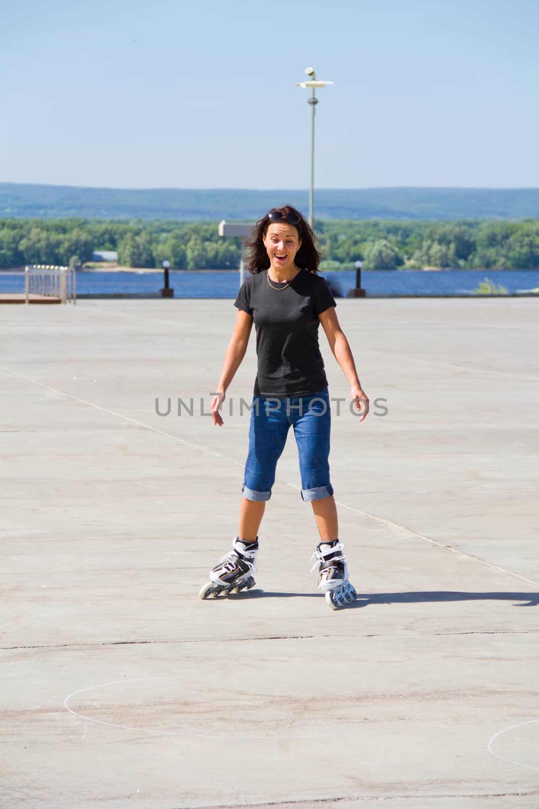 Young woman on roller skates in summer