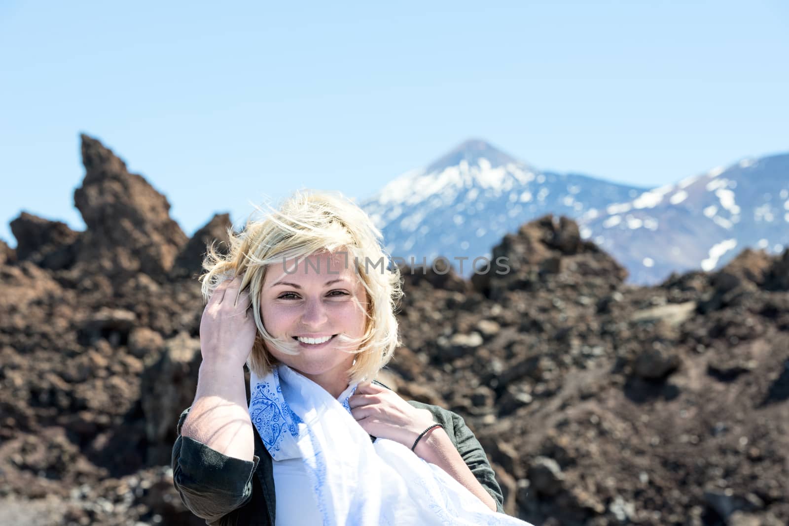 Smiling blond woman with Teide volcano on background