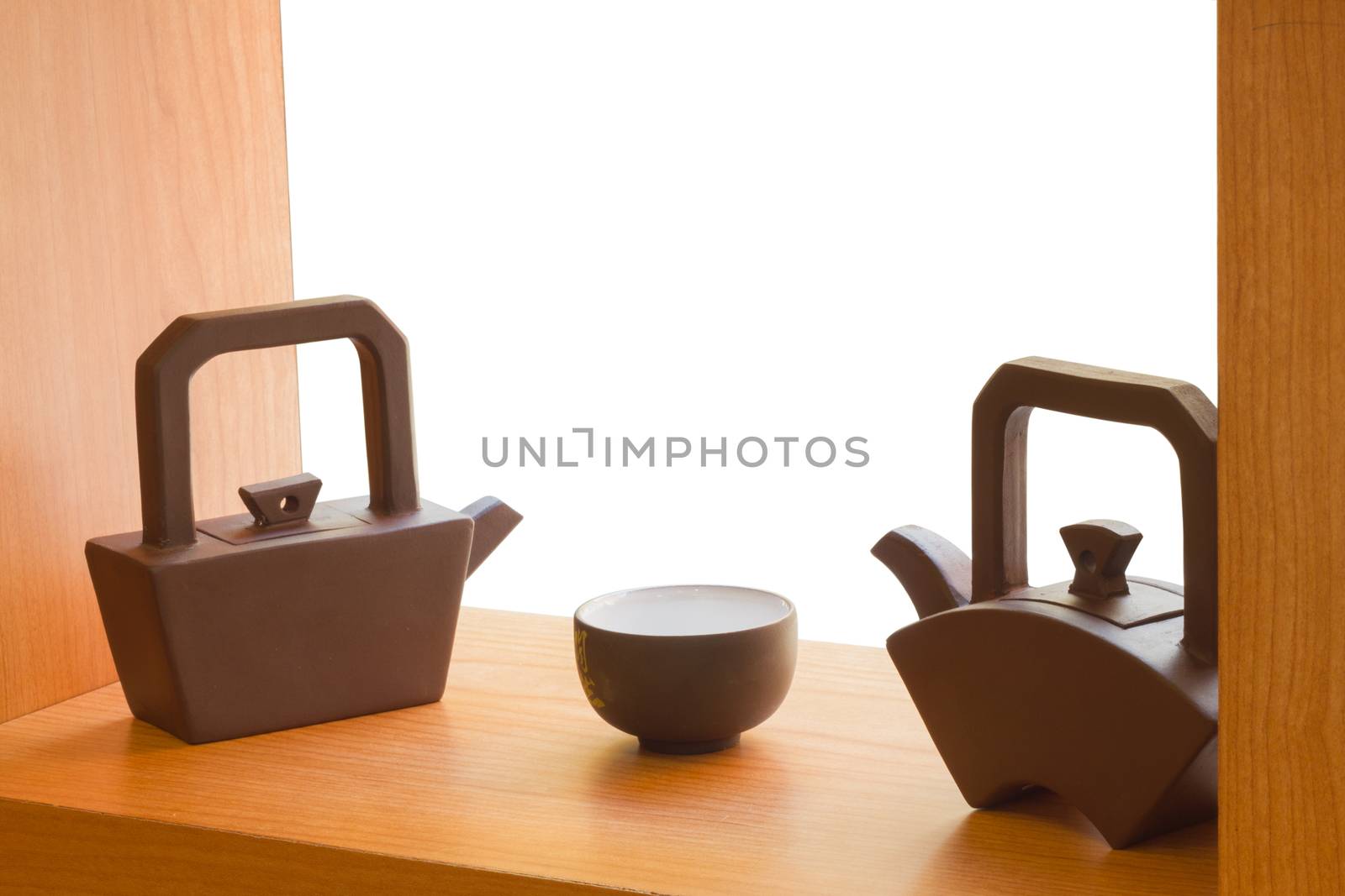 Chinese teapots and cup on wooden table in white background