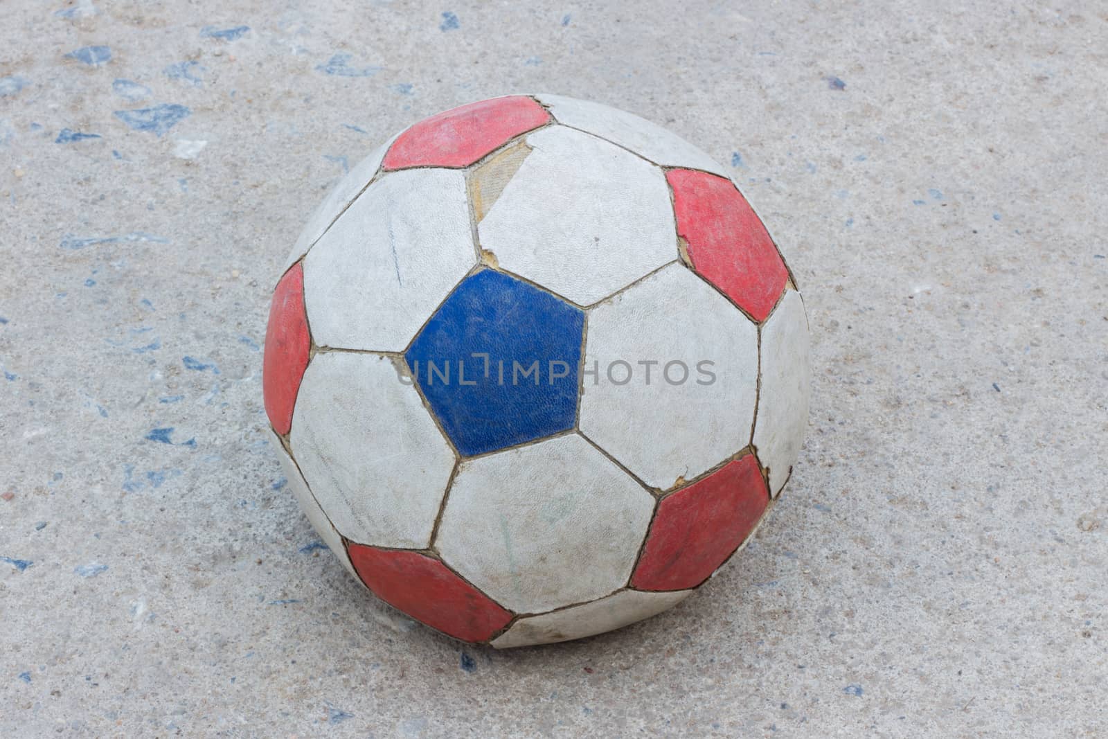old soccer ball on concrete field