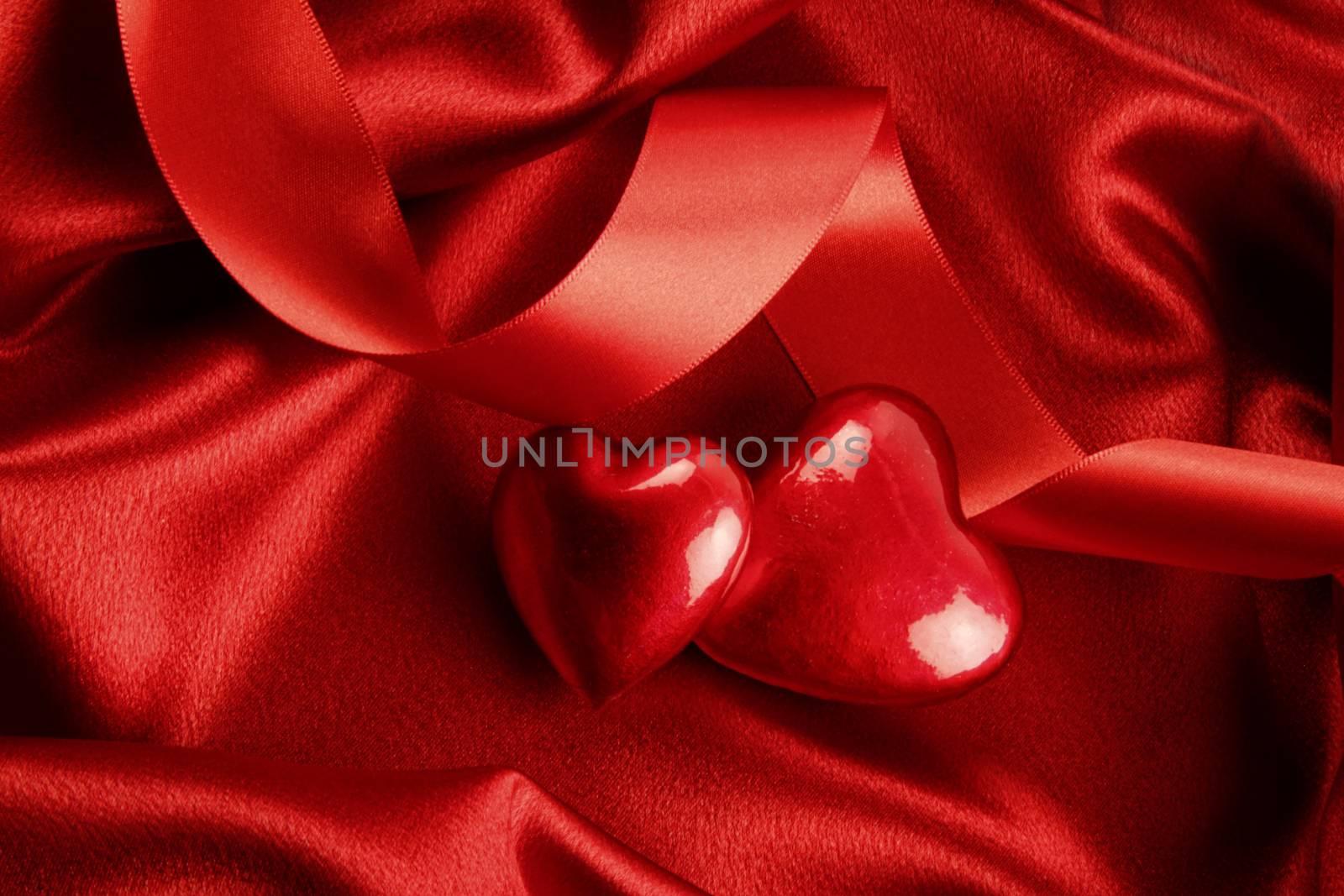 Red hearts on satin background by Sandralise
