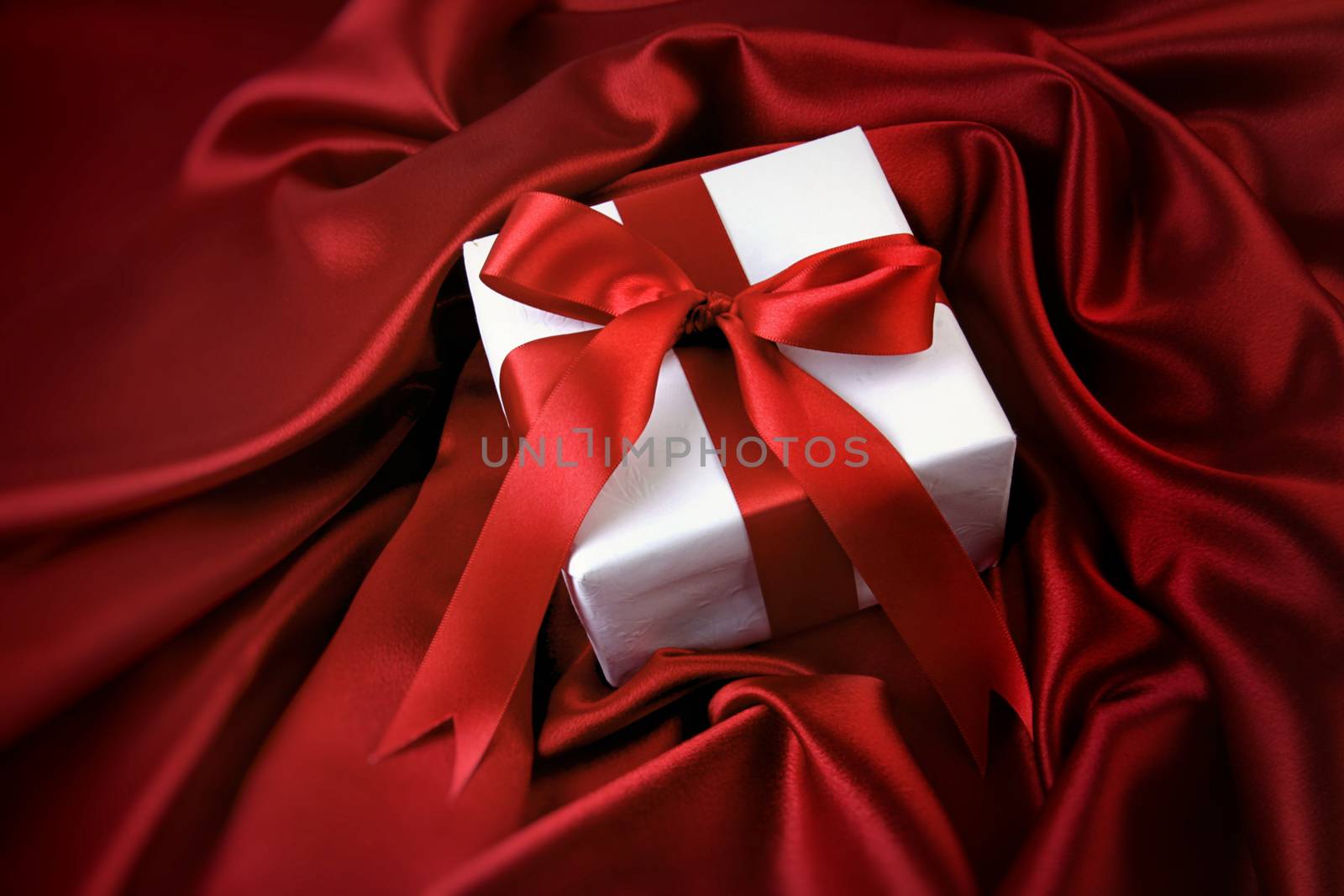 Small valentine gift on red satin by Sandralise
