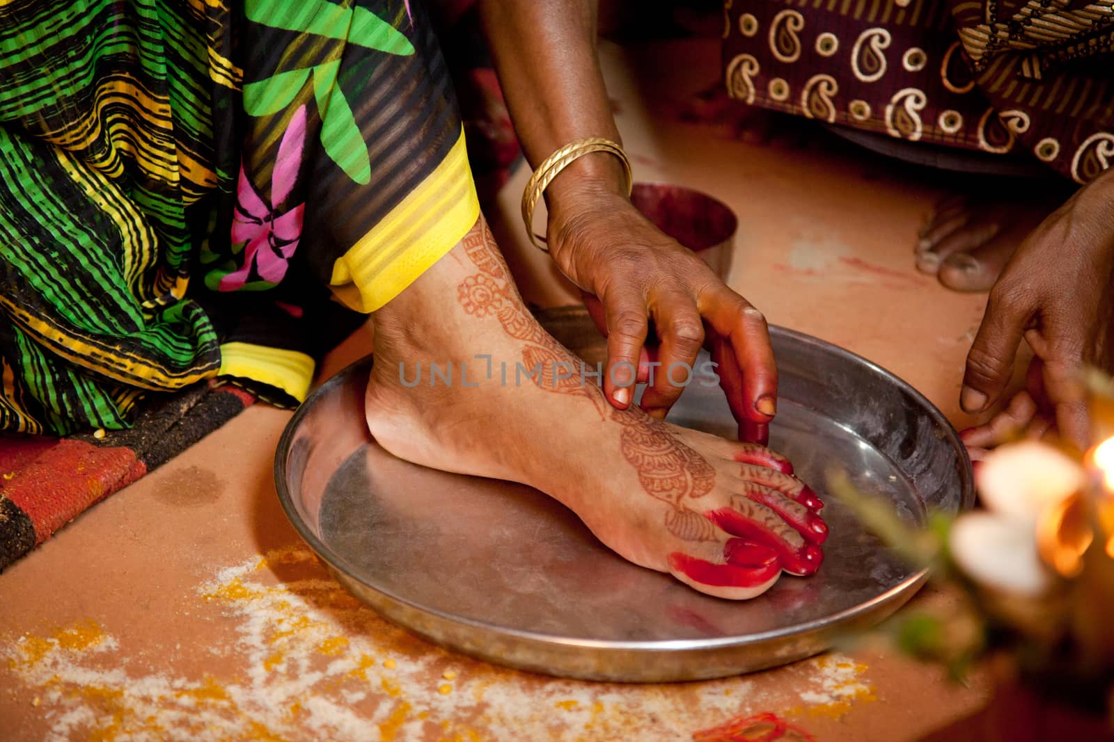 Indian bride doing marriage rituals doing colored foot fingure their mandap puja