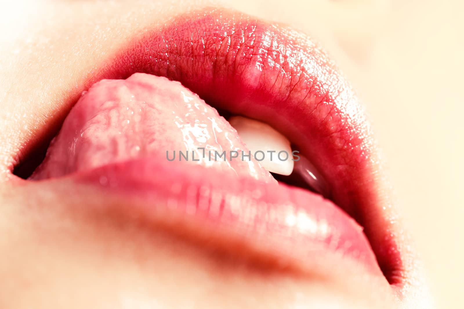 Beautiful woman seductively licking lips