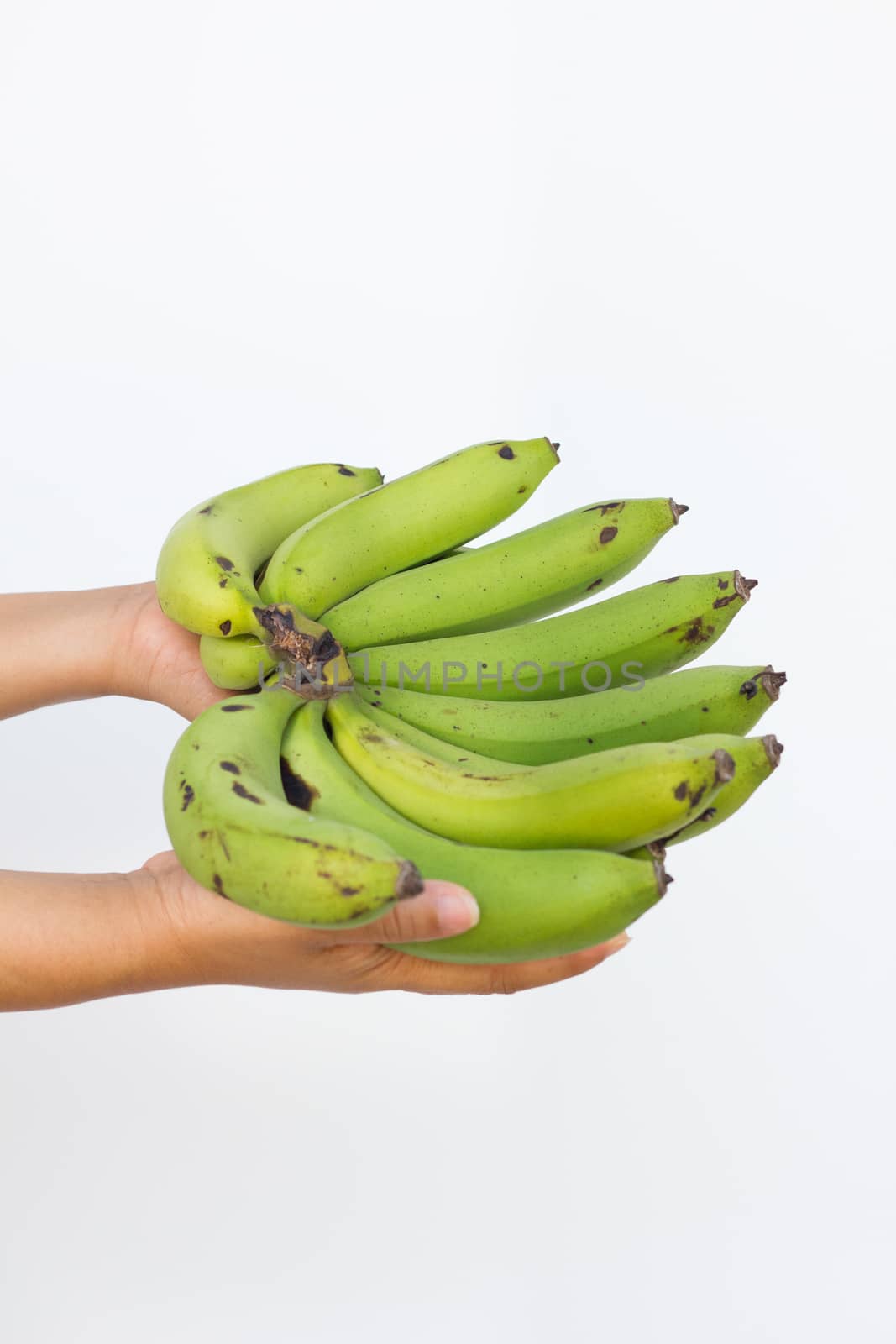 a banana in woman's hand isolated on a white background