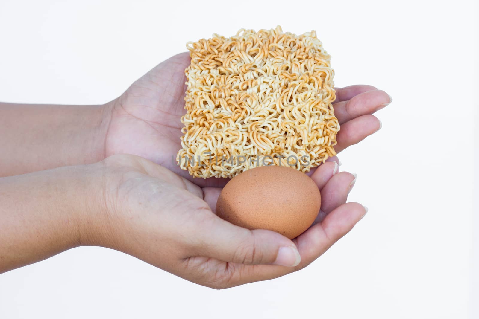hand holding instant noodles and egg isolated on white background