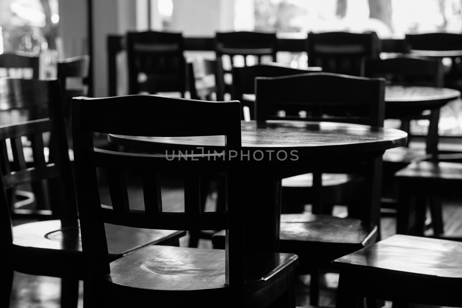 black & white of empty tables and chiar in coffee shop by a3701027