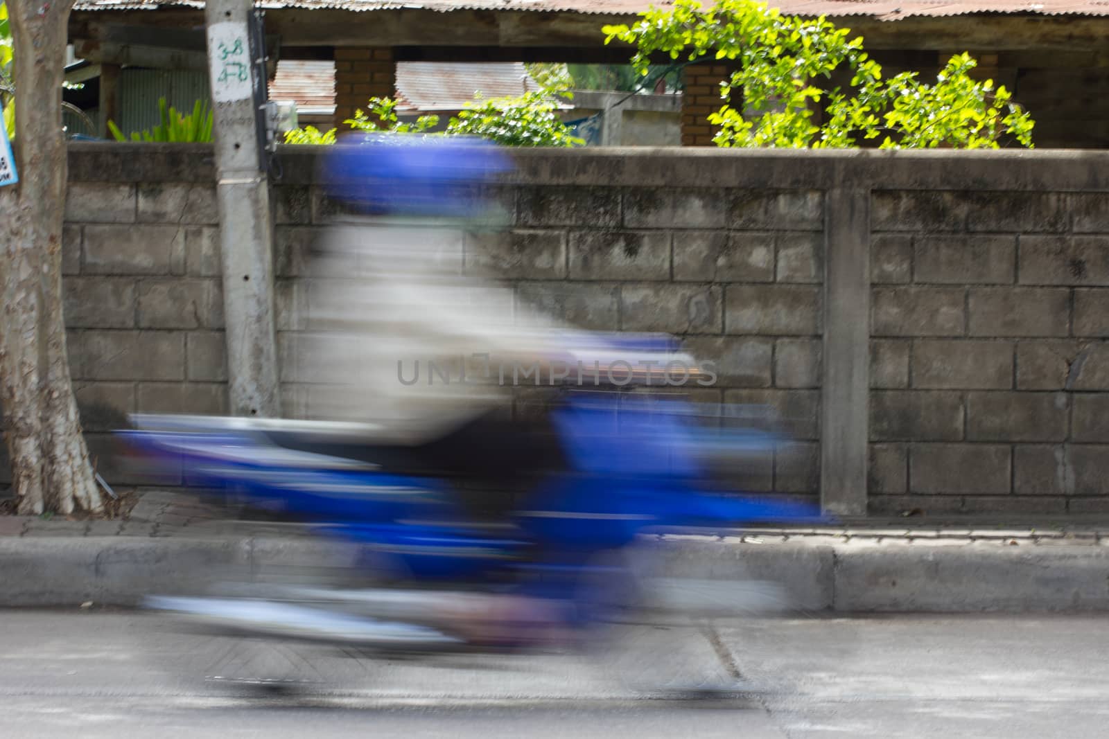 Blurred image of vehicles running on street in Thailand (motion blur image)