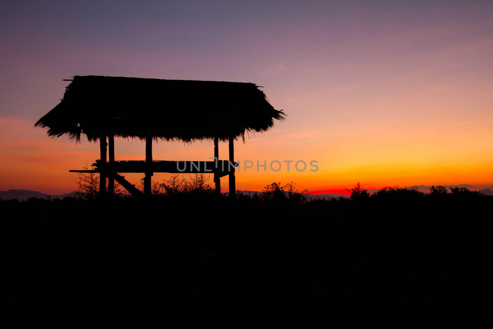 hut in silhouette style in the evening before sunset