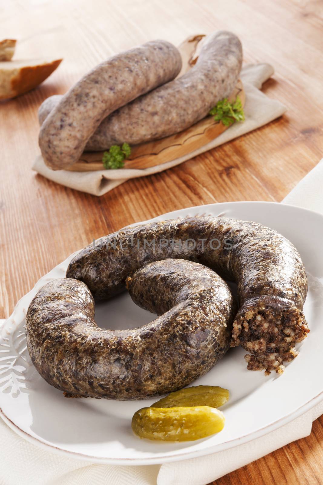 Blood sausage and rice sausage on wooden background. Culinary traditional european eating, rustic style.