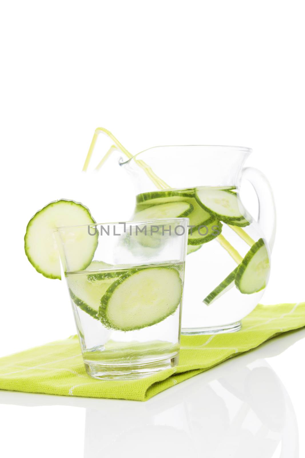 Fresh cucumber lemonade in glass and jar on white background. Healthy fresh summer drink. 