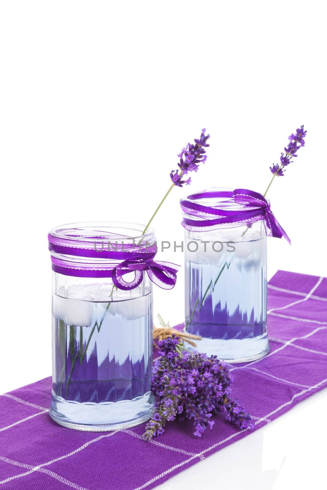 Fresh organic lavender lemonade with fresh lavender blossom isolated on white background. Healthy fresh nonalcoholic summer drink. 