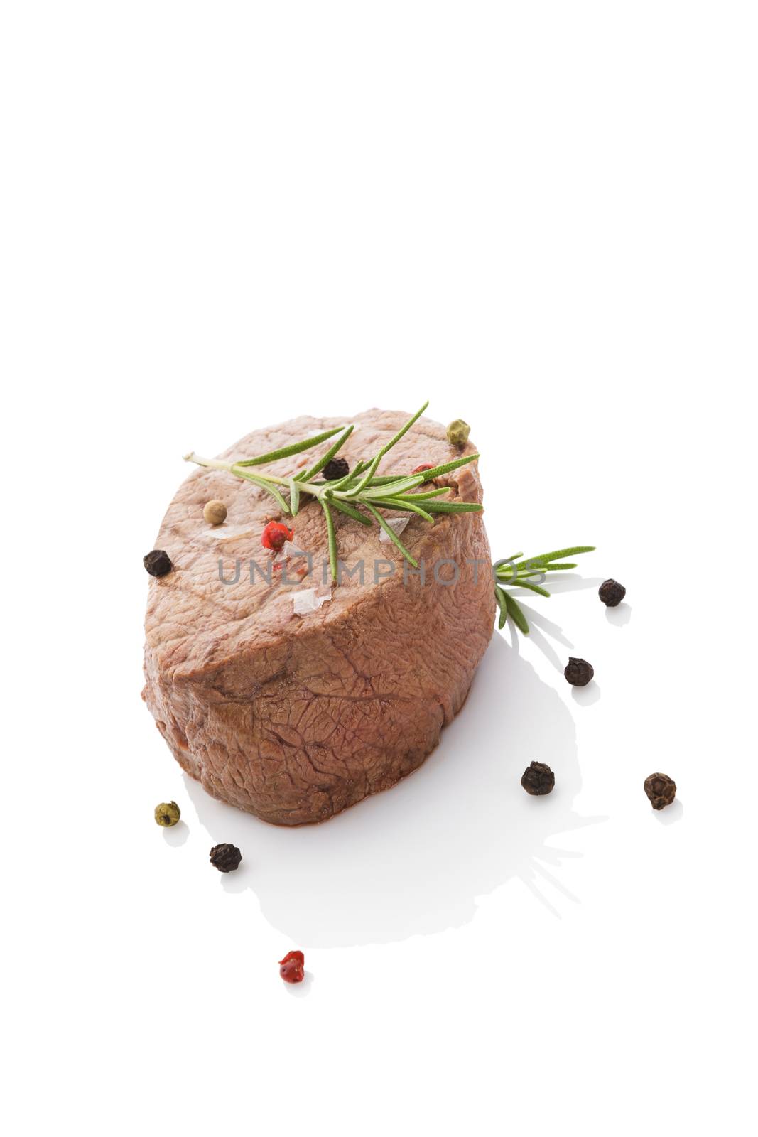 Beefsteak isolated on white background with colorful peppercorn. Culinary red meat eating. 