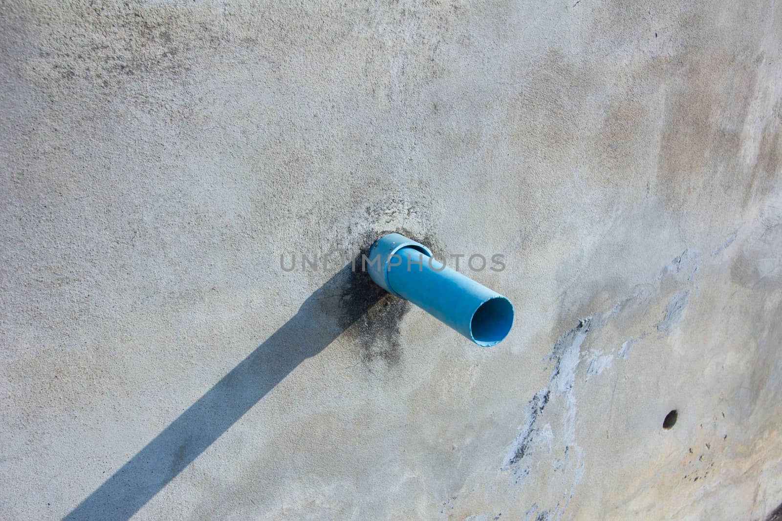 waste pipe on a wall in sunshine