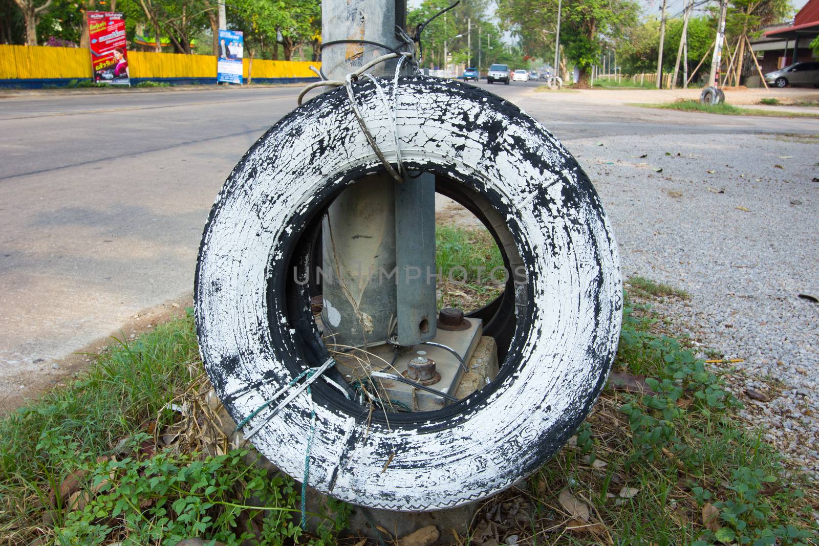 used car tire painted in white used for car accident protection in Thailand