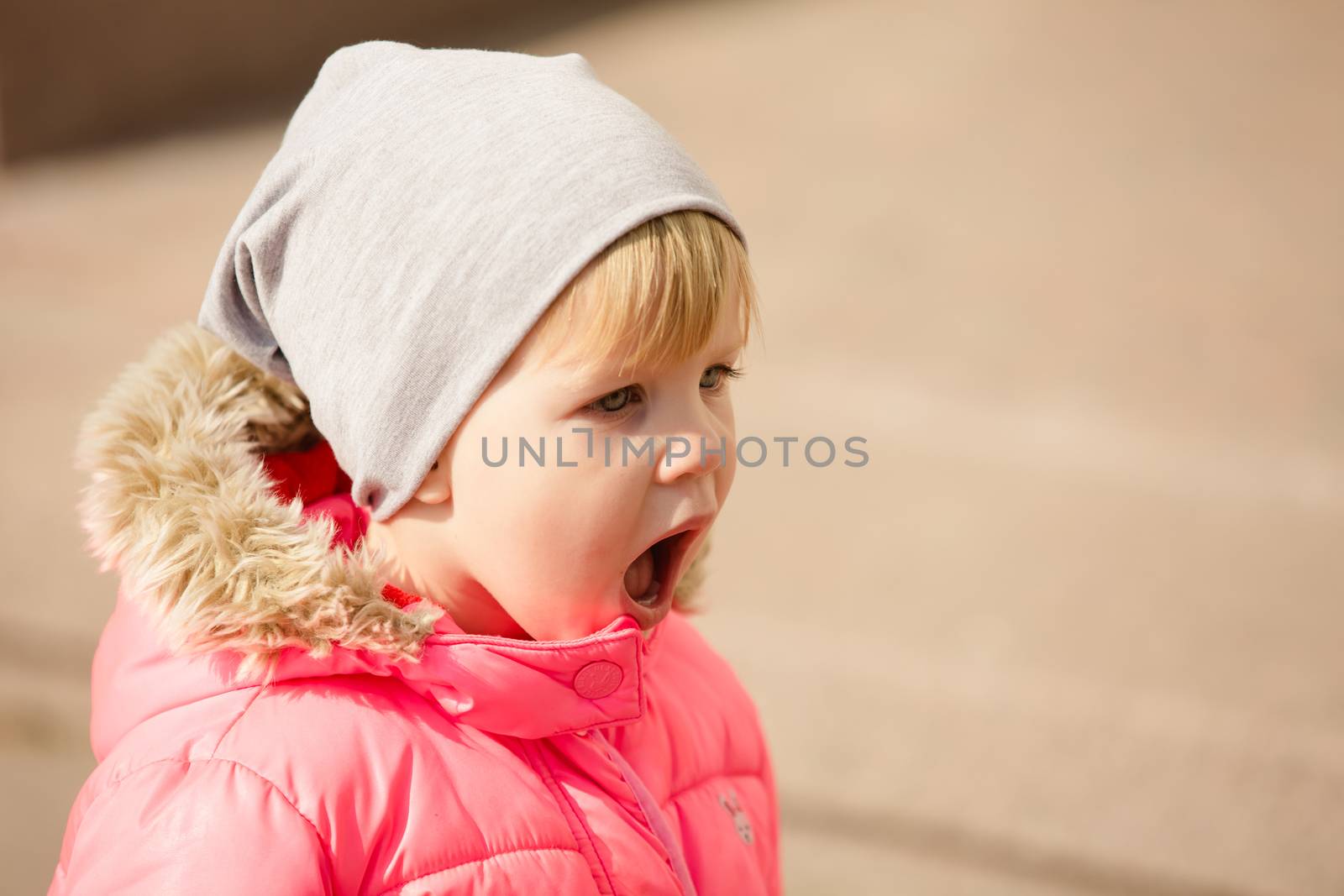 attractive little girl on outdoor playground equipment