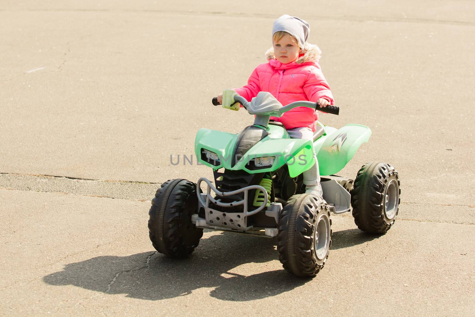 attractive little girl on outdoor playground equipment