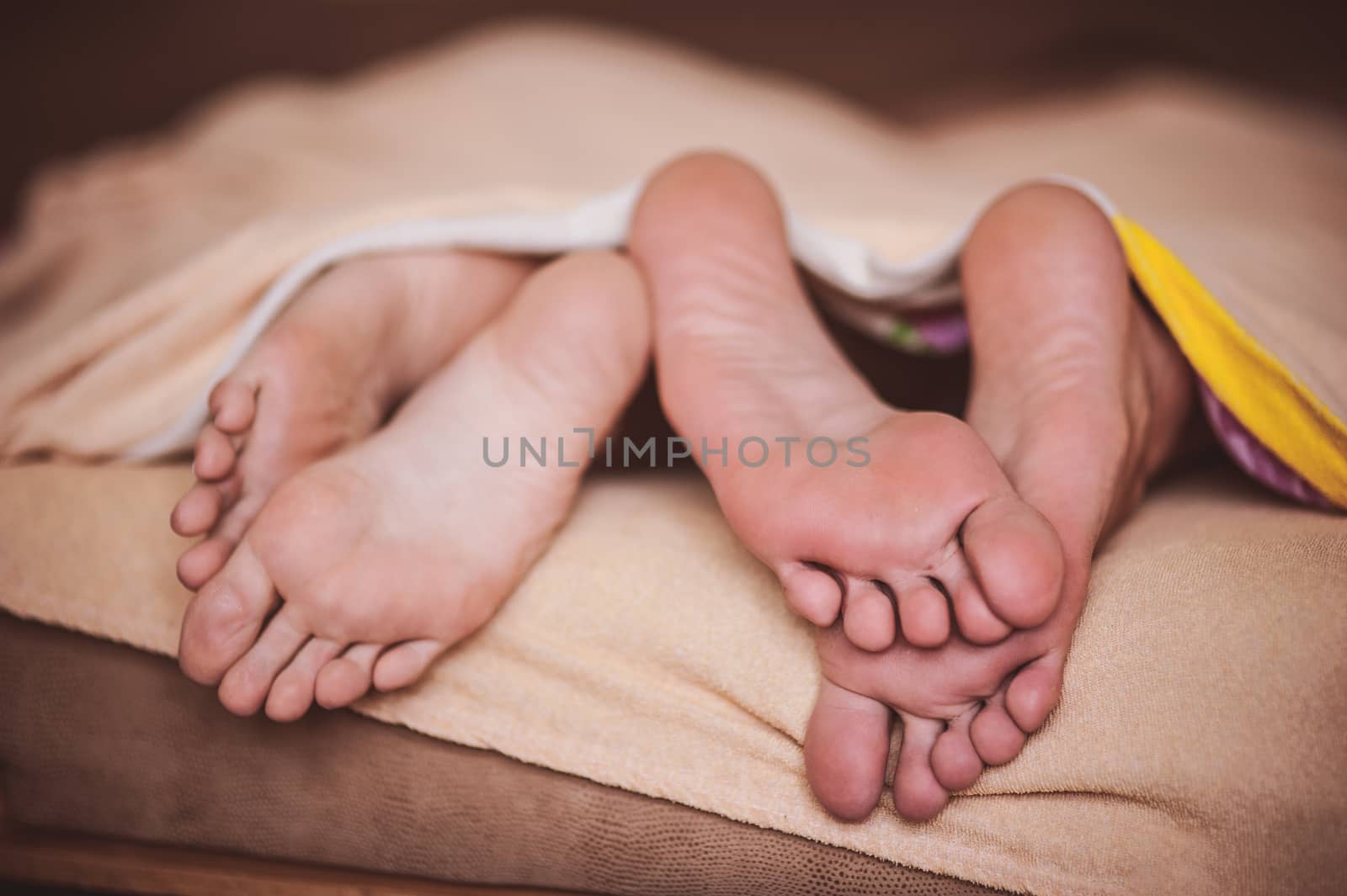 couple barefoot in bed no face  by fesenko