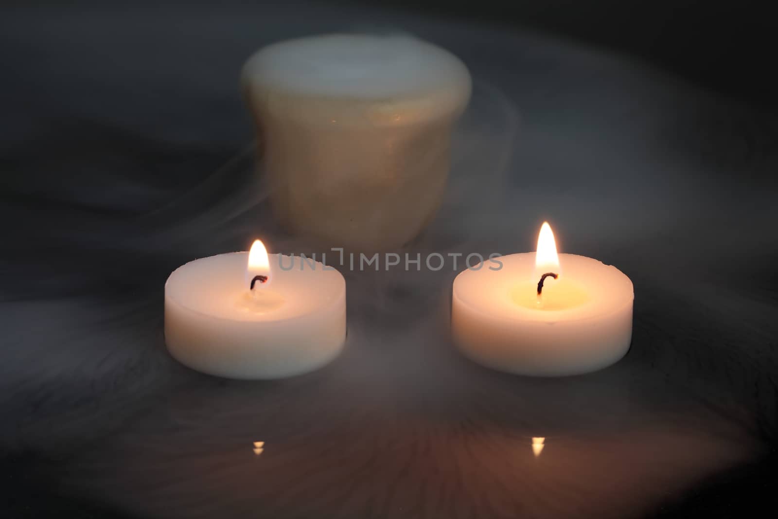 A candles with a pot of dry ice.