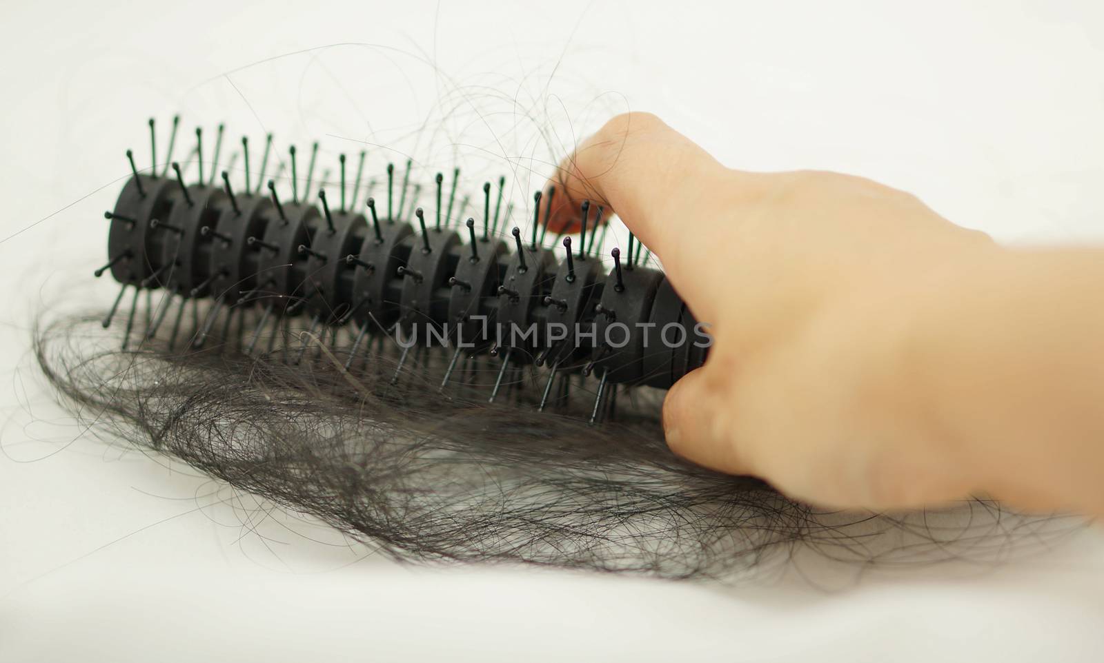 Women with hair loss problems, there are many hair attached to a comb after use.                               