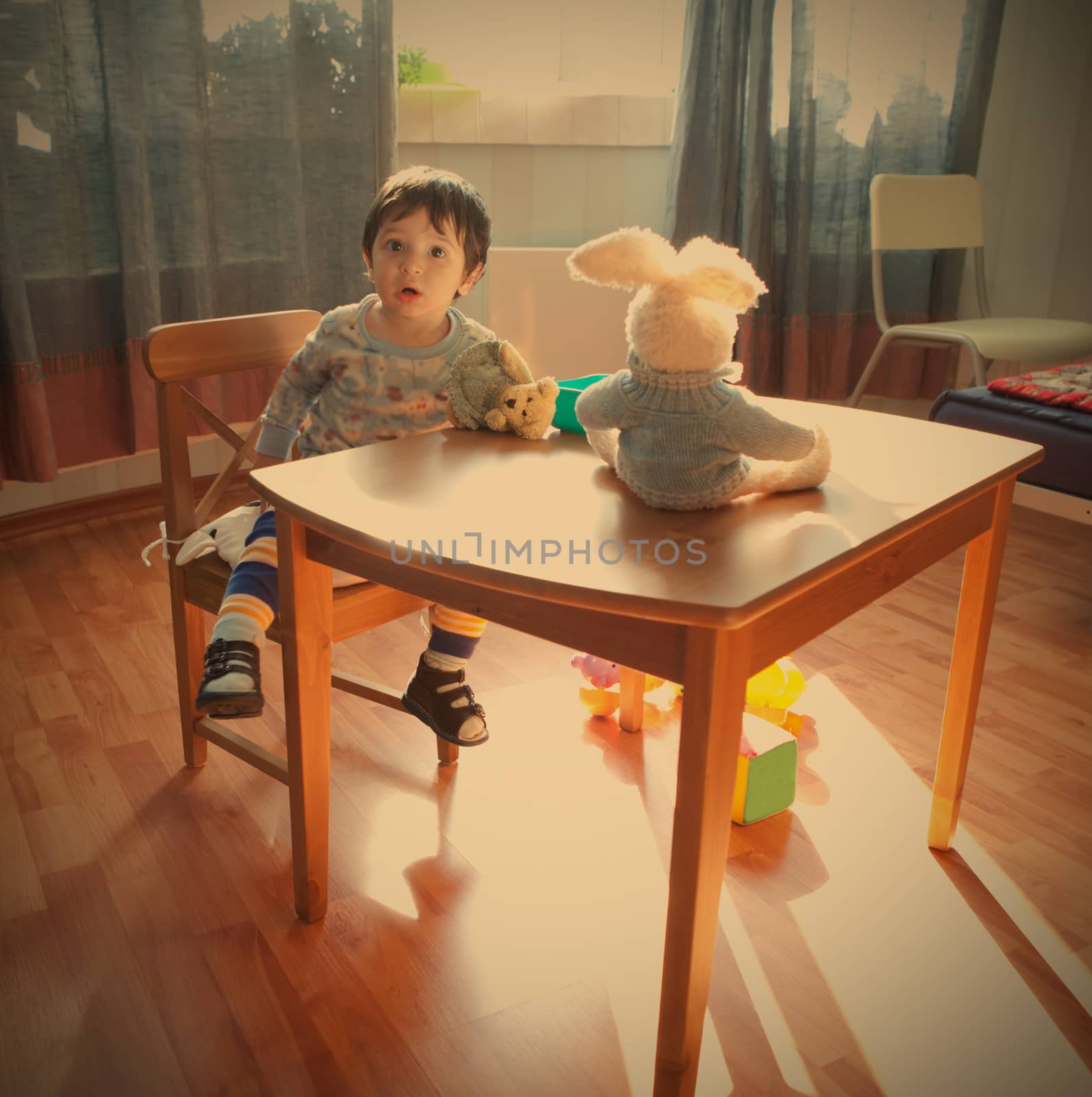 baby sits on chair in interior of the playroom, instagram image style