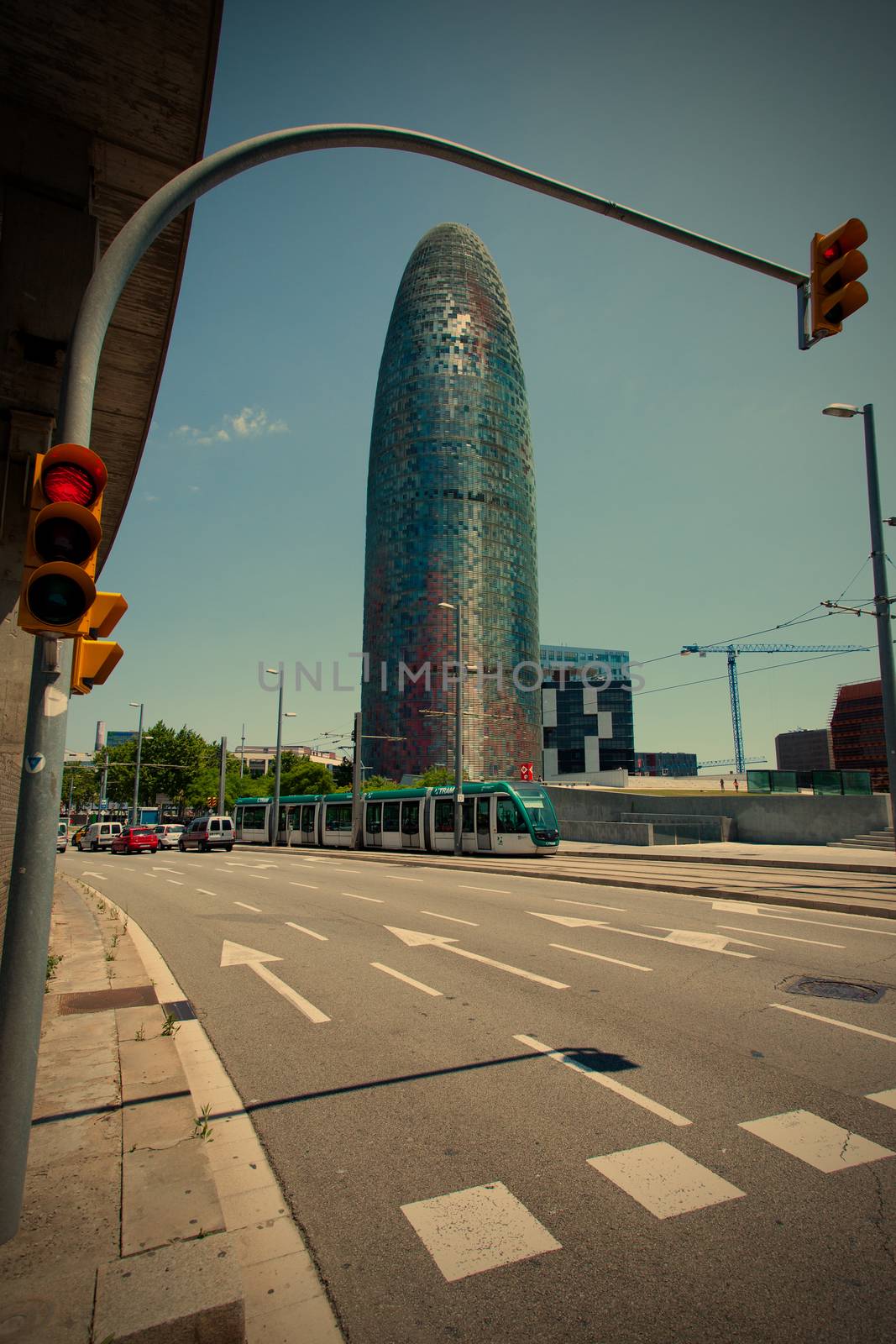 Spain, Catalunya, Barcelona 14.06.2013, the city's landscape with the building Torre Agbar, traffic lights and speed tram, instagram filter style, editorial use only