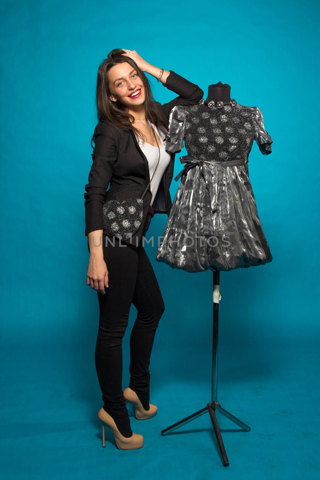 Woman with mannequin, on blue background