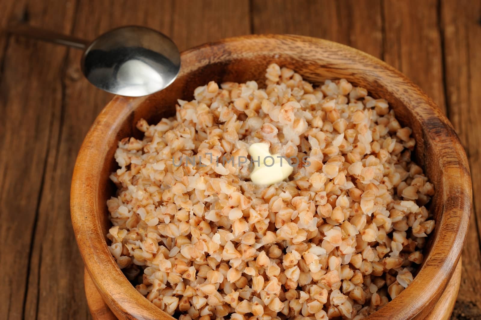 Russian buckwheat kasha in wooden bowl  closeup macro horizontal