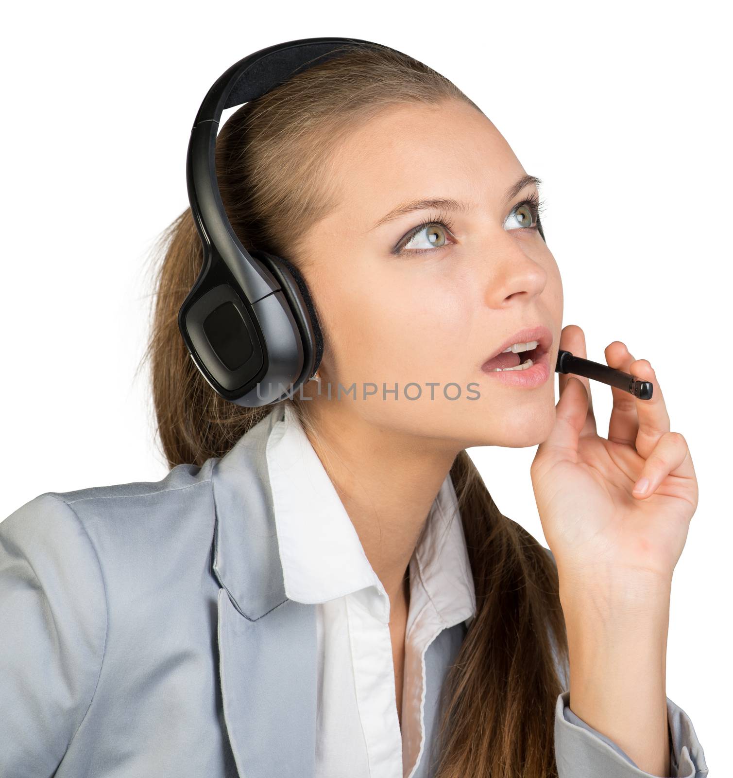 Businesswoman in headset, with her fingers on microphone boom by cherezoff