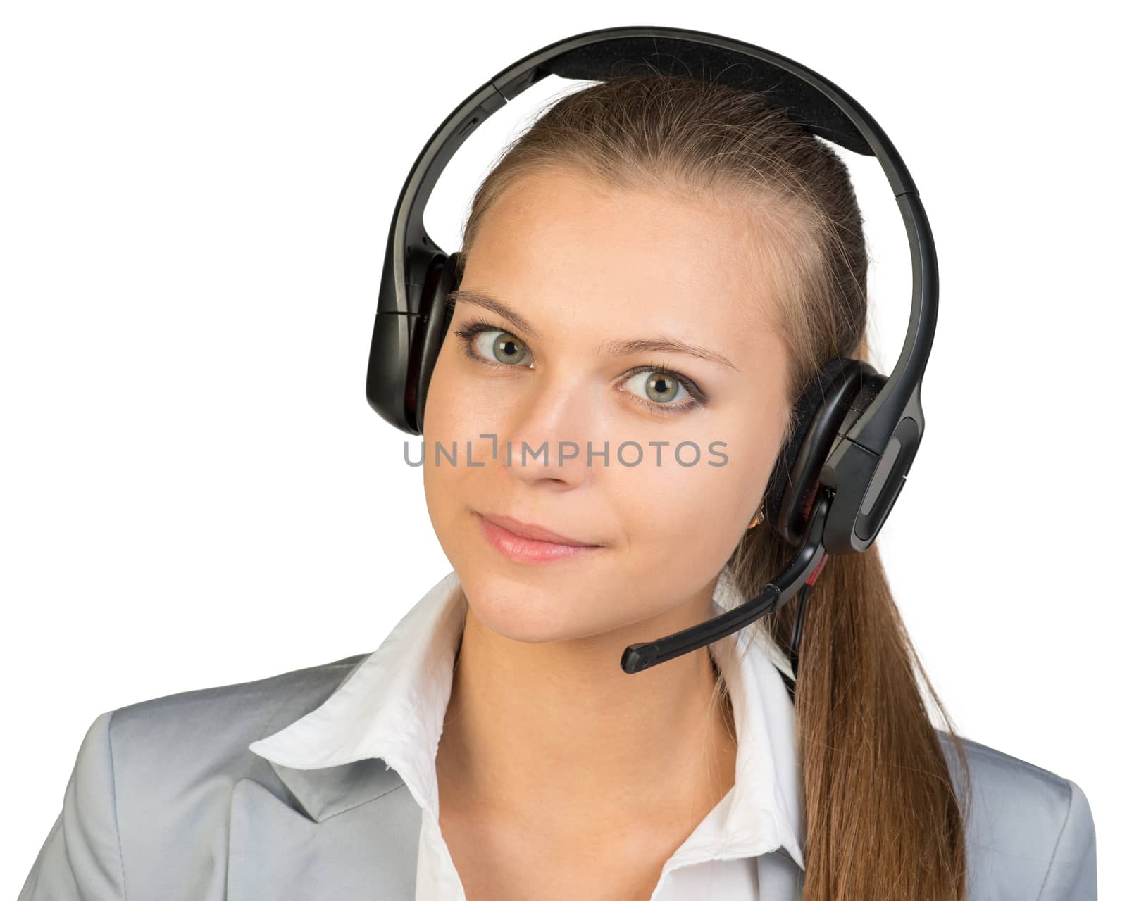 Businesswoman in headset, her head tilted slightly to the side, looking at camera. Isolated over white background