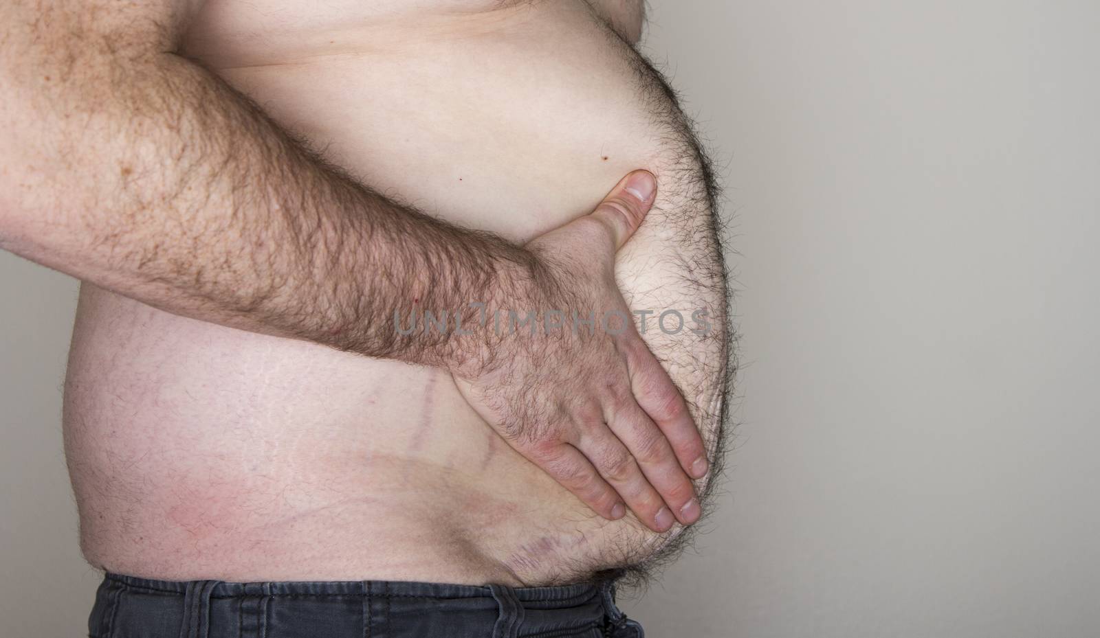Profile view of a large mans belly with some copy space to the side
