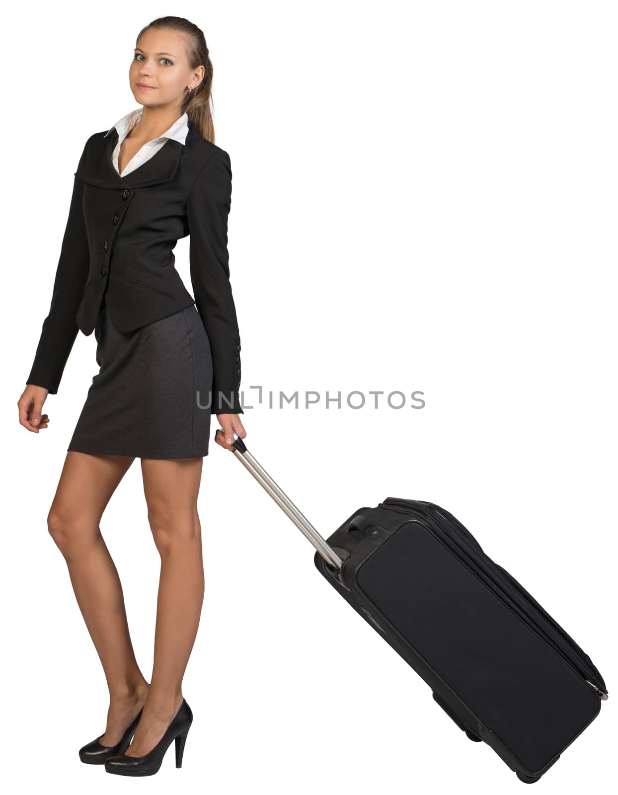Businesswoman holding wheeled bag in moving position, looking at camera, smiling. Isolated over white background