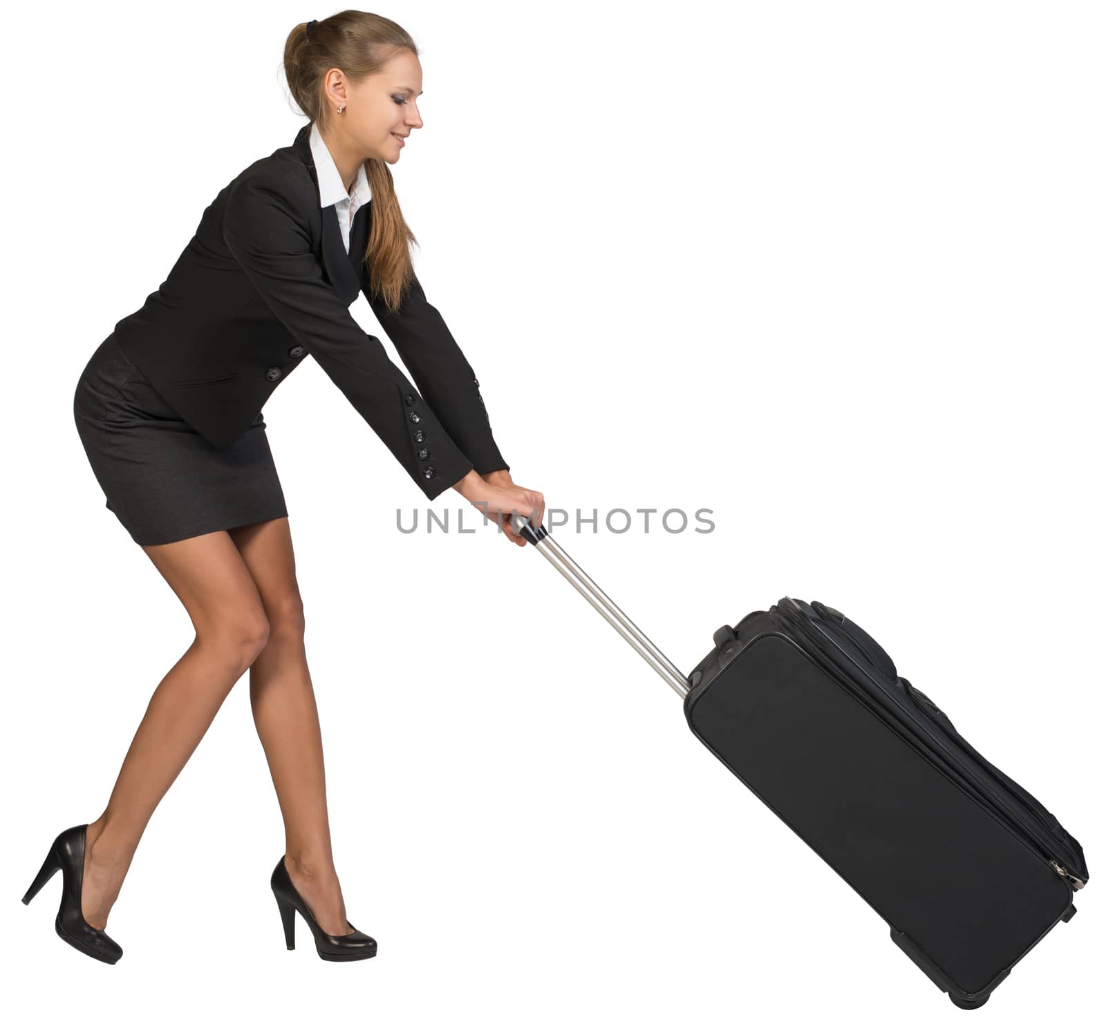 Businesswoman dragging heavy wheeled suitcase at utmost strain by cherezoff