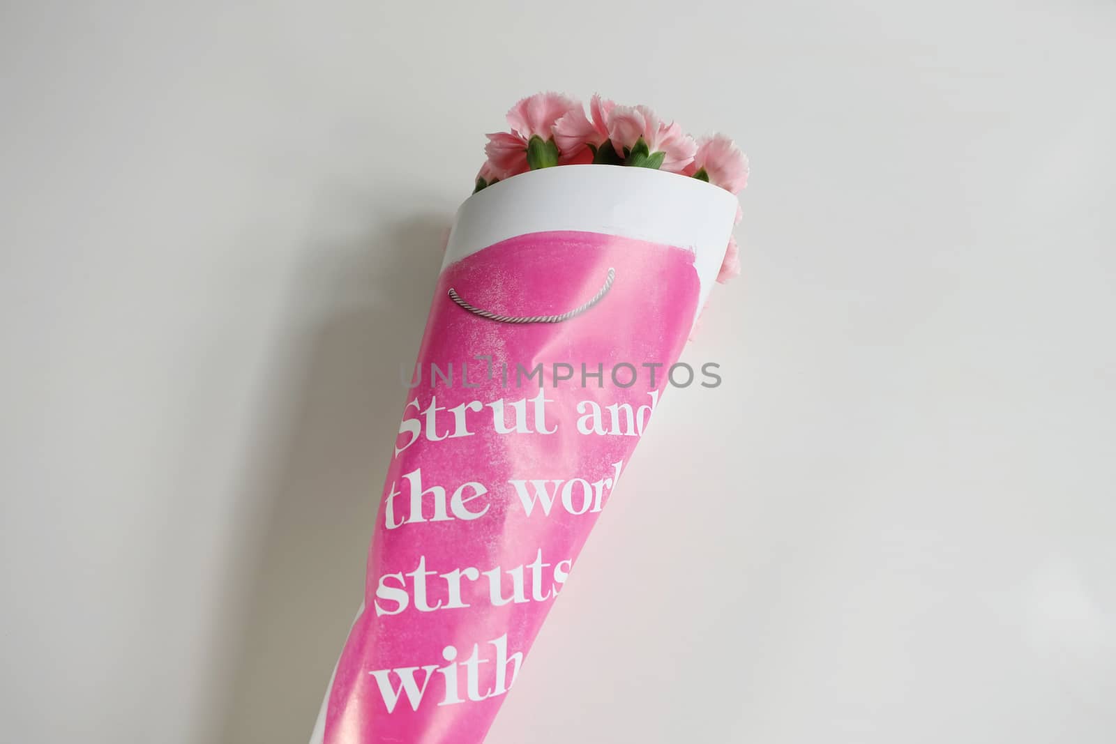 Bouquet of pink carnations wrapped in paper