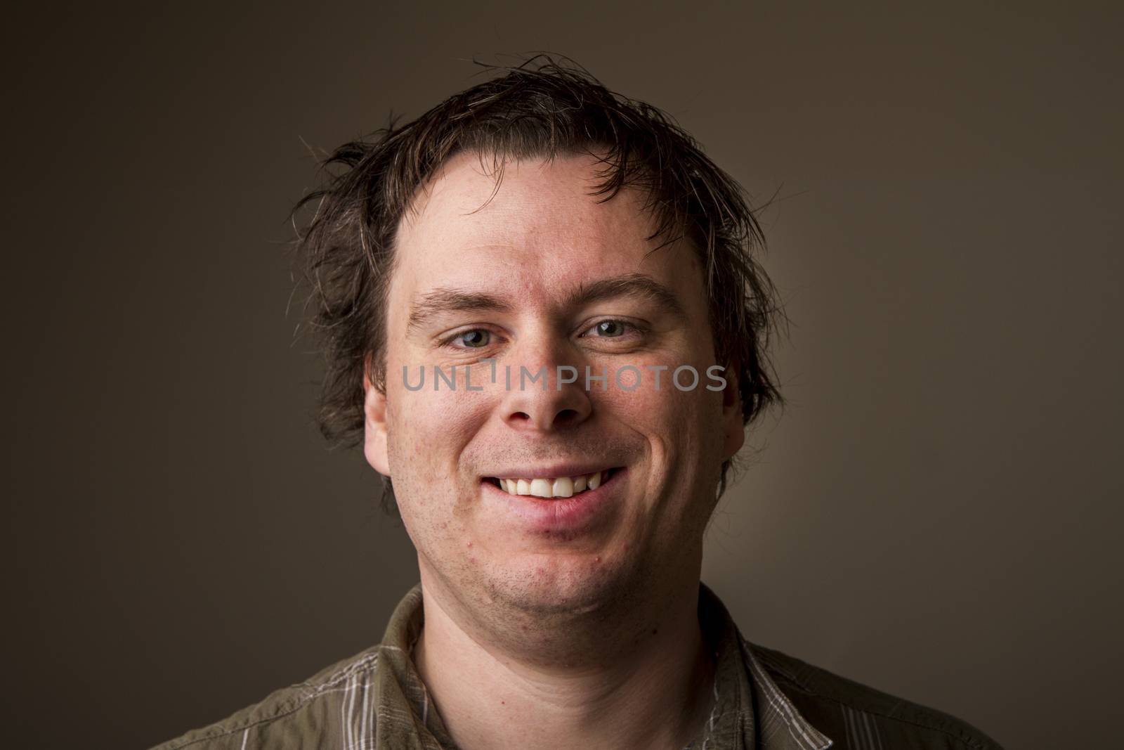 Just some dude making some weird smile with messy hair