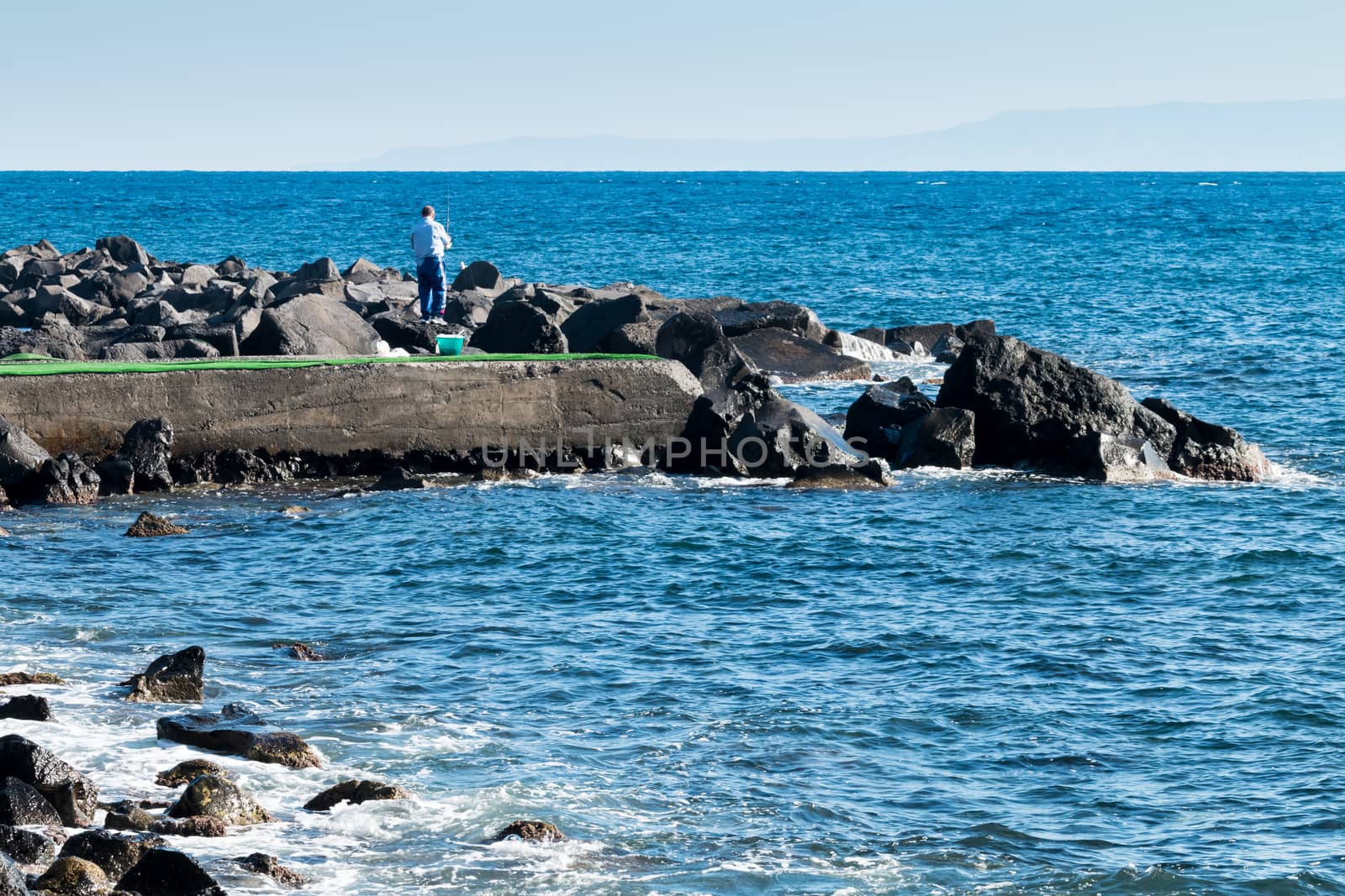 Fisherman morning on the small pier Torre Archirafi