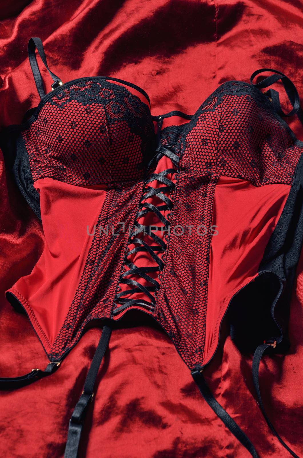 Red corset decorated with black lace