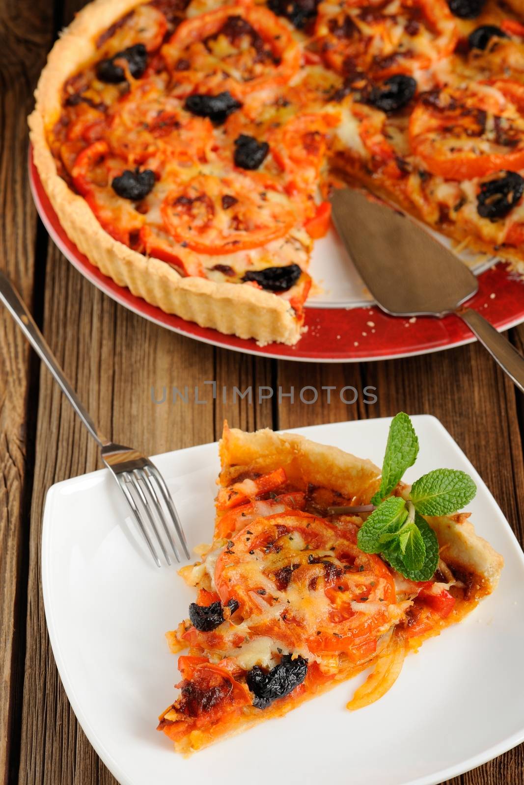 Tomato tart with olives on wooden background closeup macro