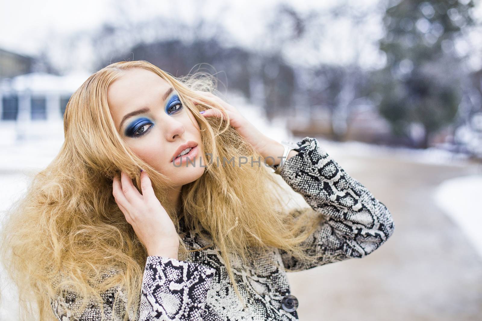 Girl with a blue makeup is walking in the park