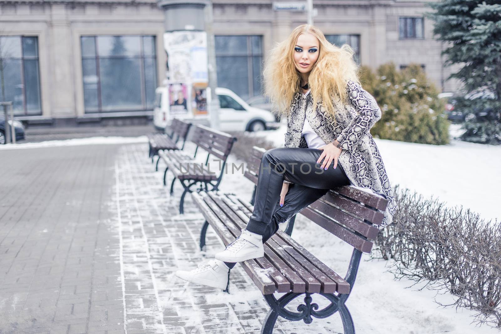 Woman on a bench in the city by Kor