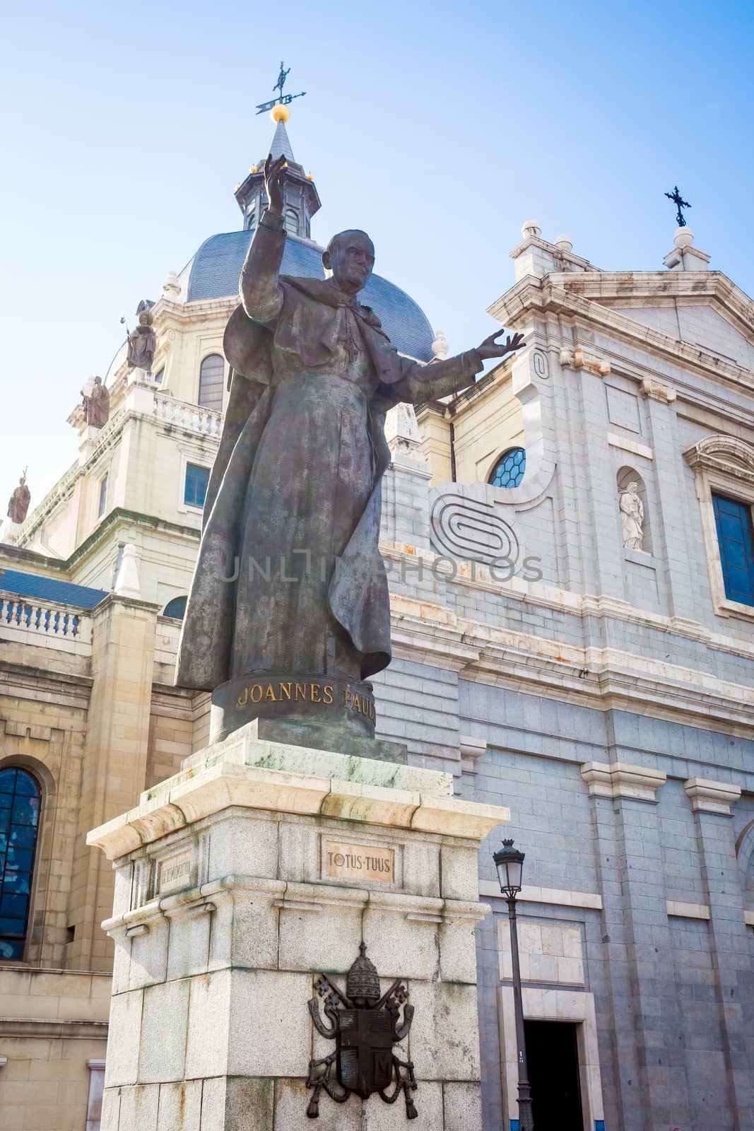 Madrid, Spain - May 6, 2012: Pope John Paul II statue in front of Cathedral Almudena on a spring day in Madrid, Spain
