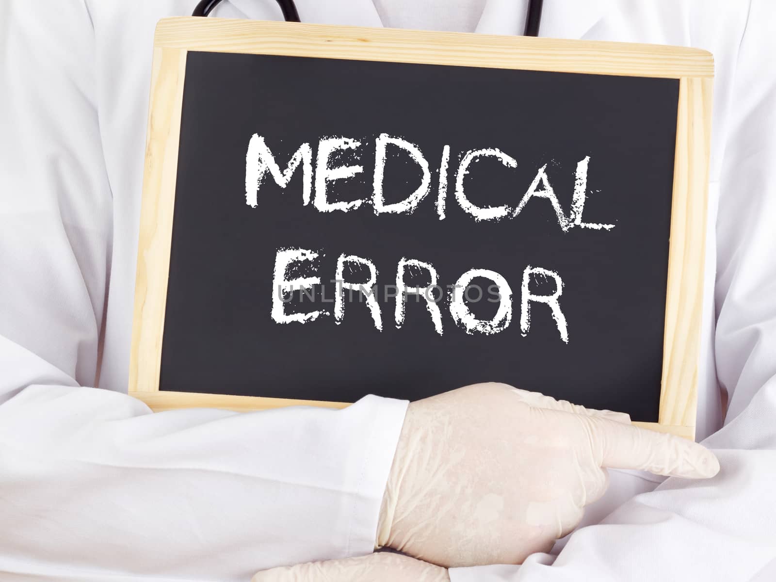 Doctor shows information on blackboard: medical error by gwolters