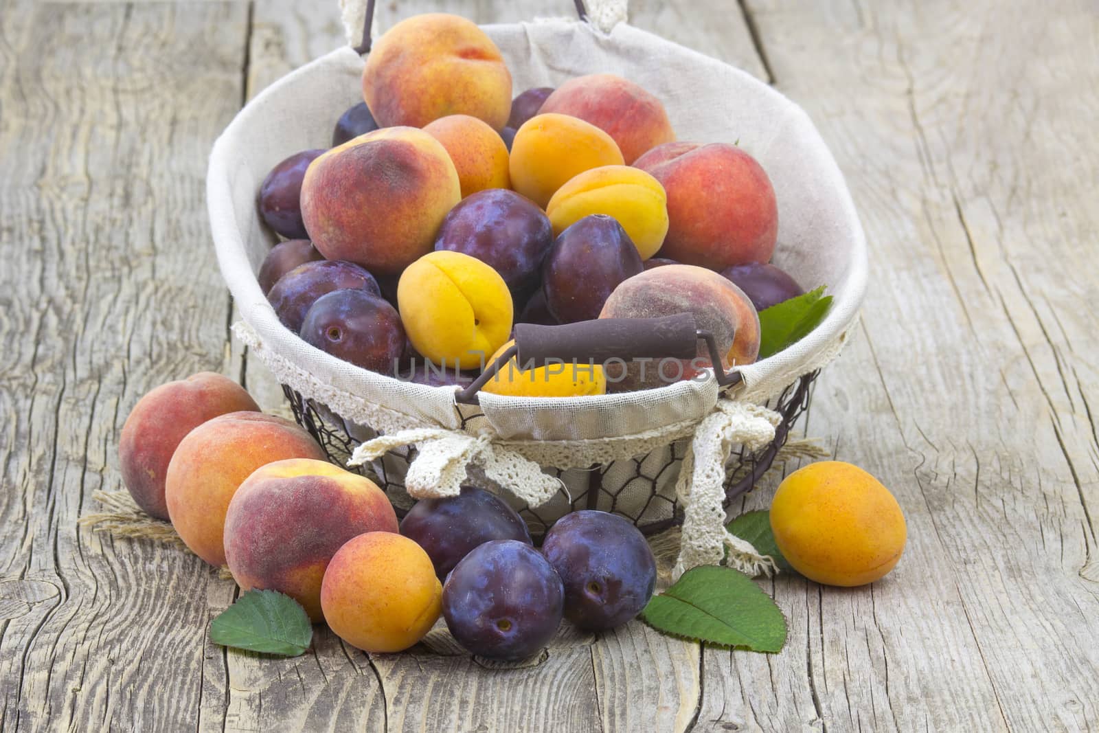 fresh fruits in a basket on wooden background