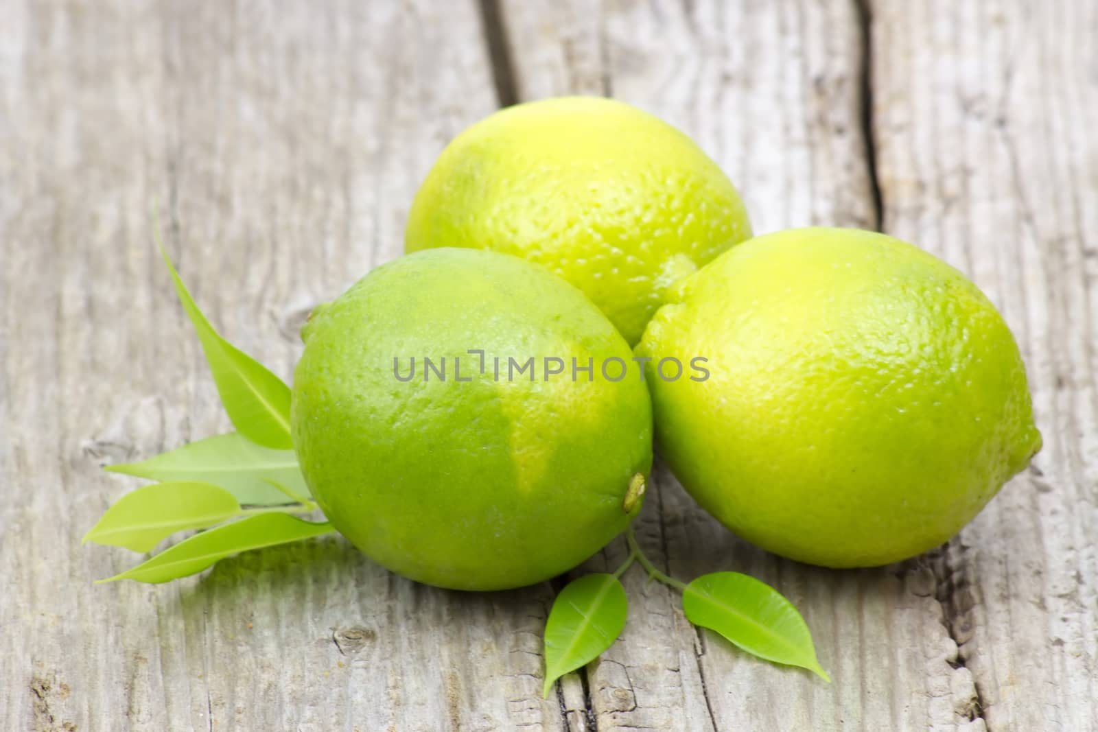 fresh lime fruits on wooden background