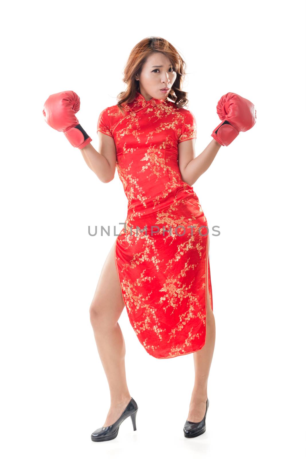 Chinese woman dress traditional cheongsam and boxing gloves, full length portrait isolated.