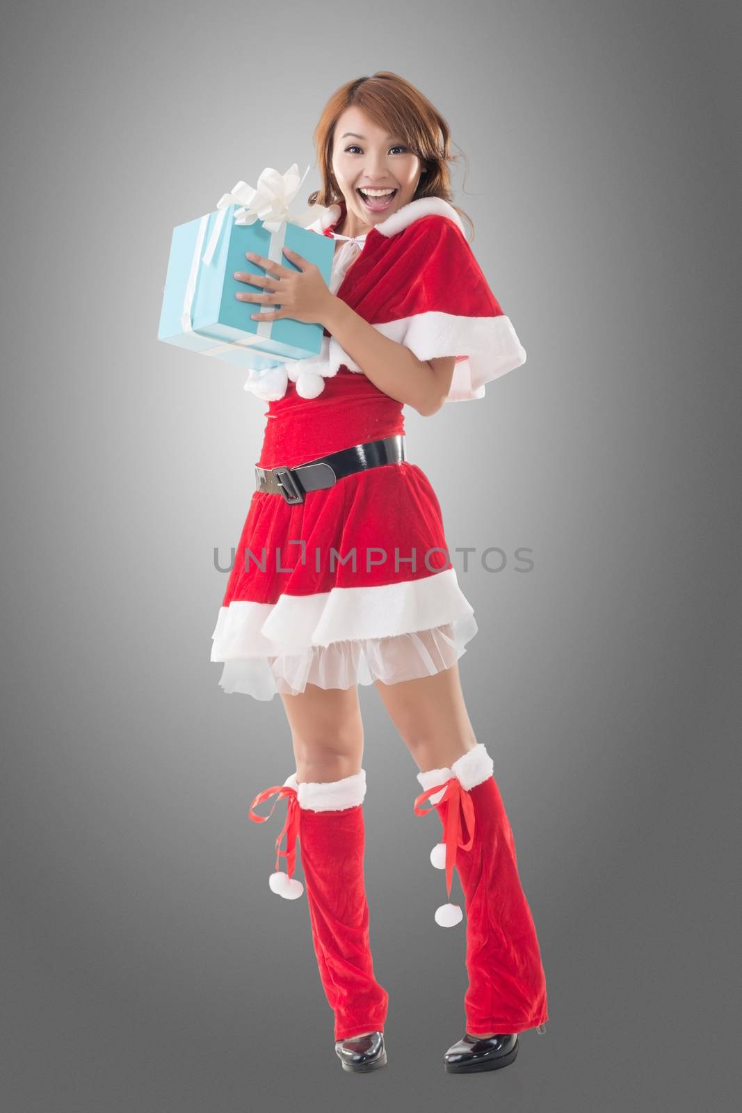 Smile happy Asian Christmas girl hold gift box, isolated full length portrait.