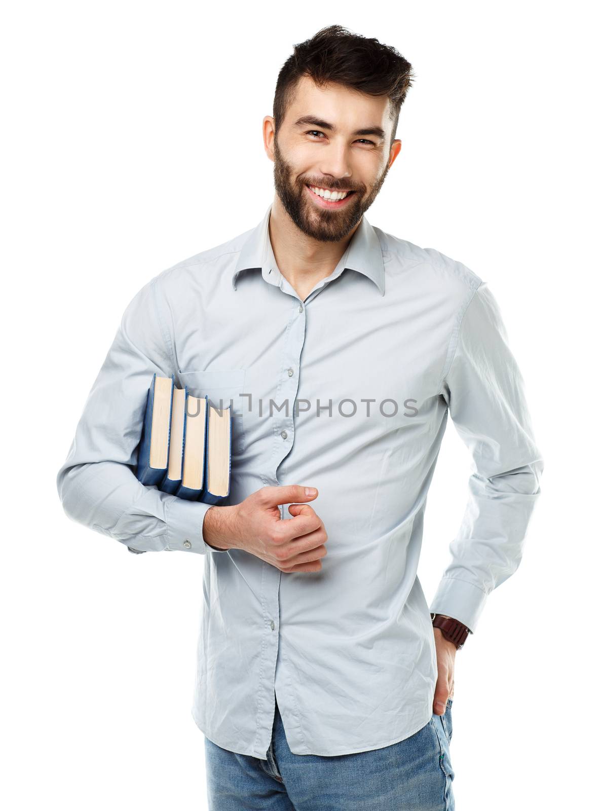 Young bearded smiling man with books in hand on white background