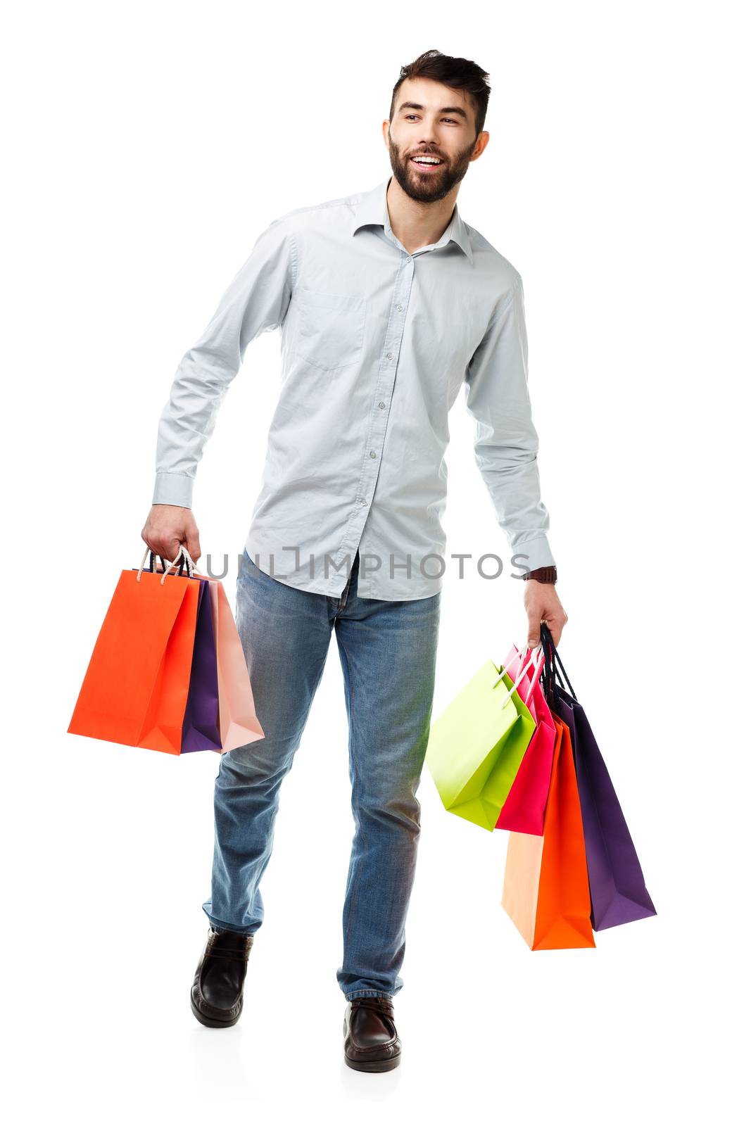 Handsome man holding shopping bags on white background by vlad_star